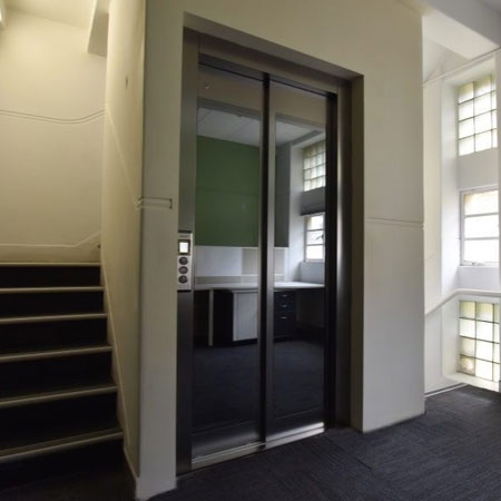 Commercial Stretcher lift with automatic sliding cabin and landing doors, 1000kg load capacity.